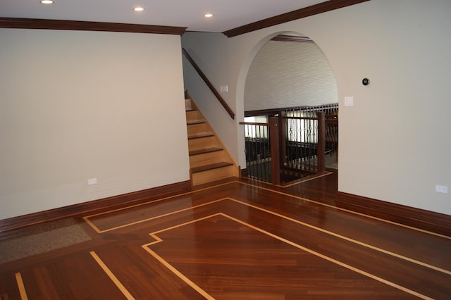 staircase with recessed lighting, crown molding, arched walkways, and wood finished floors