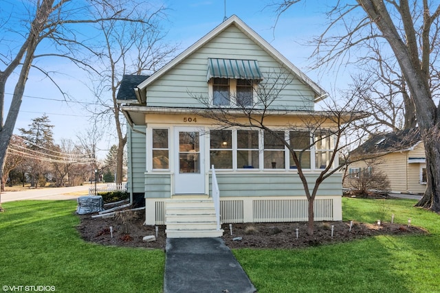 view of front facade with roof with shingles, a front yard, and entry steps