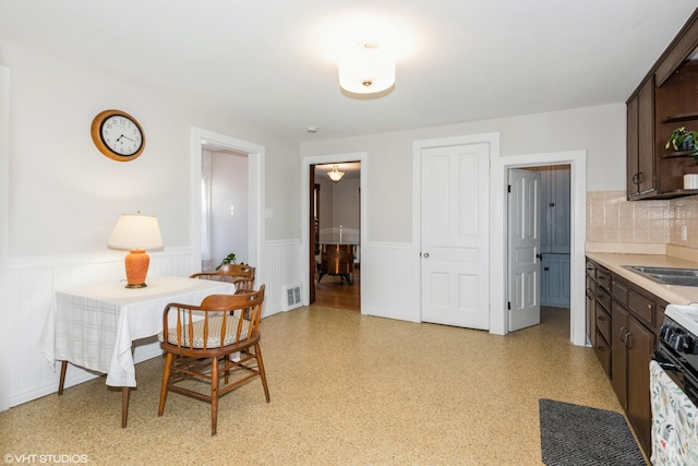 dining room featuring a wainscoted wall and visible vents