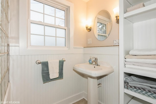 bathroom with a wainscoted wall and a sink