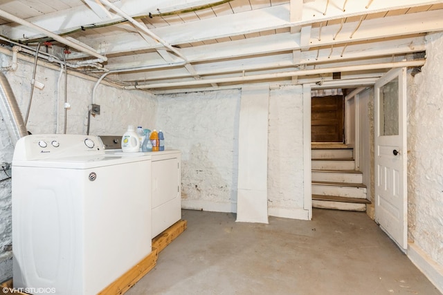 unfinished basement featuring stairway and independent washer and dryer