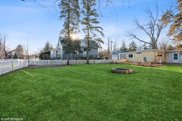 view of yard featuring an outdoor fire pit and a fenced backyard