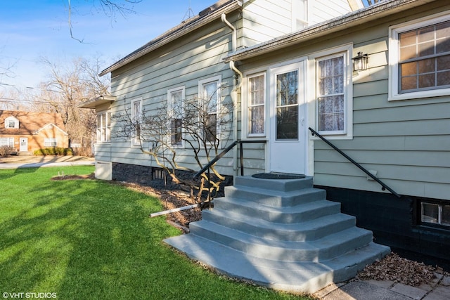 doorway to property with a lawn