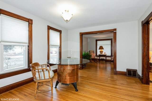 dining area with visible vents, baseboards, and light wood-style flooring