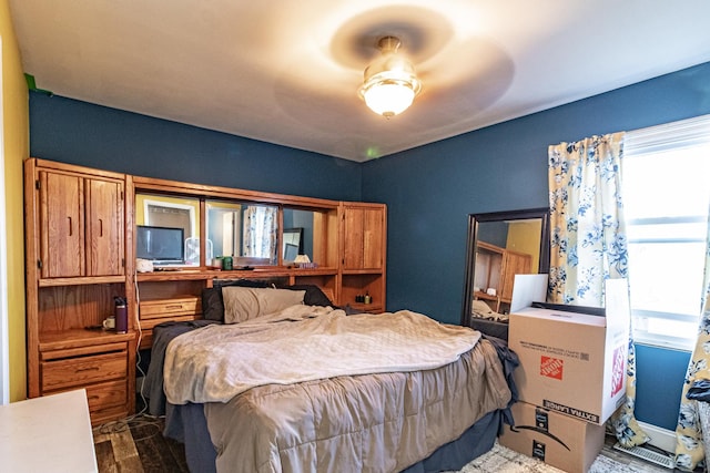 bedroom with a ceiling fan and wood finished floors