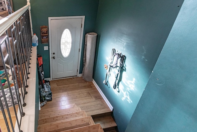 entryway featuring baseboards and wood finished floors