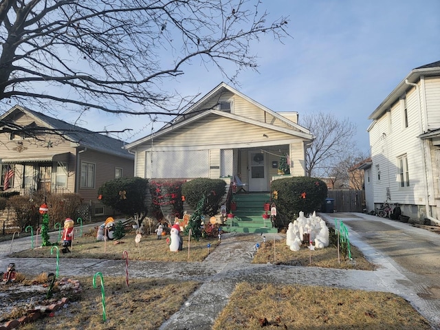 bungalow-style house featuring driveway and fence