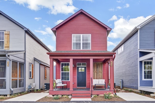 traditional-style house featuring covered porch and central air condition unit