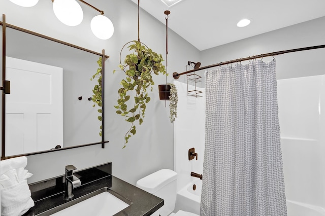 bathroom with vanity, toilet, and shower / bath combo with shower curtain