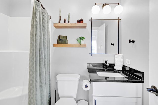 full bathroom featuring toilet, vanity, and a shower with shower curtain