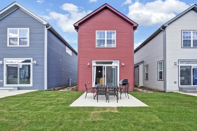 back of property with a patio and a lawn