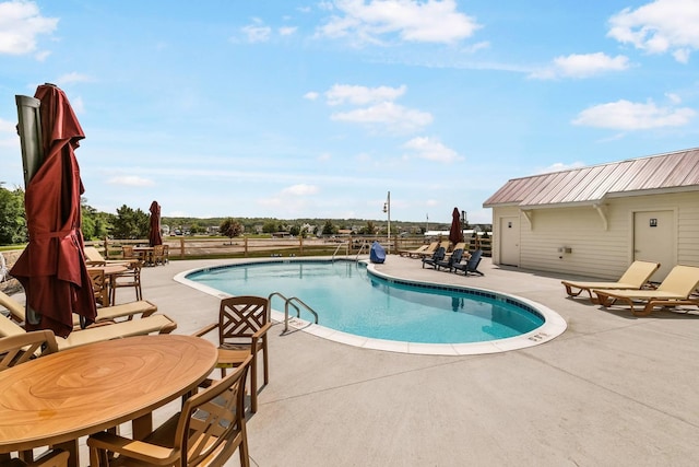 pool with fence and a patio