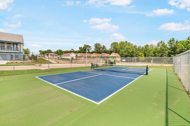 view of tennis court featuring fence