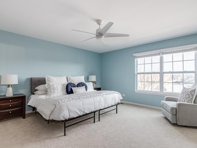 carpeted bedroom with a ceiling fan and baseboards