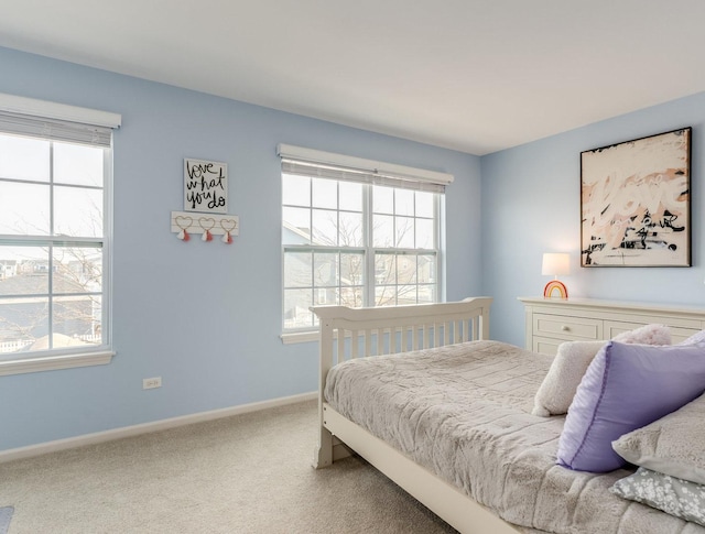 bedroom with carpet floors and baseboards