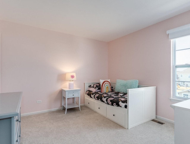 bedroom featuring light carpet, visible vents, and baseboards