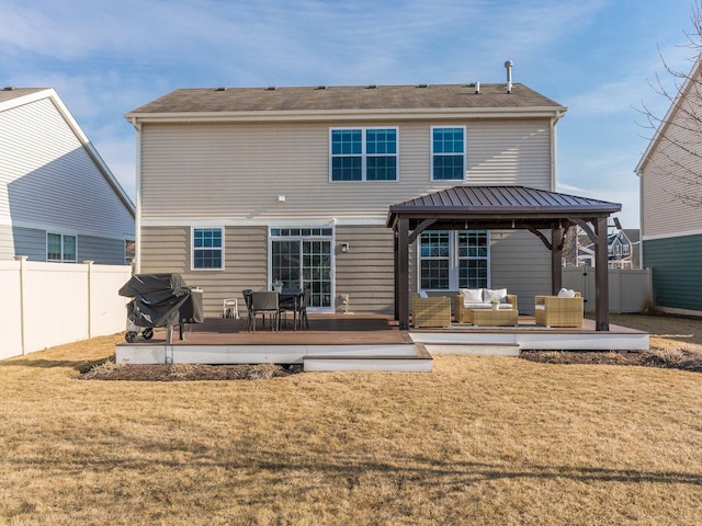 rear view of house featuring an outdoor hangout area, a gazebo, a deck, and a lawn