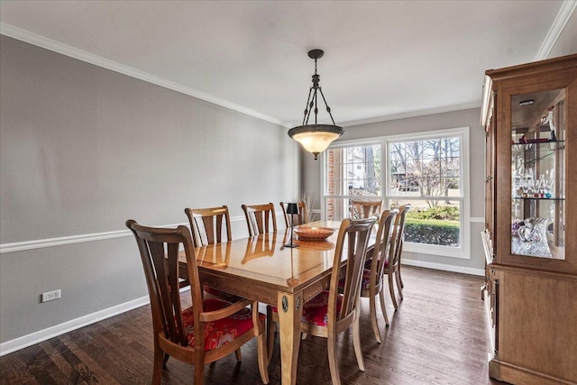 dining space featuring dark wood finished floors, baseboards, and ornamental molding