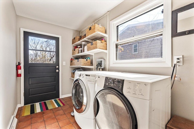 washroom with washer and dryer, tile patterned flooring, baseboards, baseboard heating, and laundry area