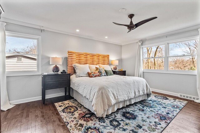 bedroom with visible vents, wood finished floors, recessed lighting, crown molding, and baseboards