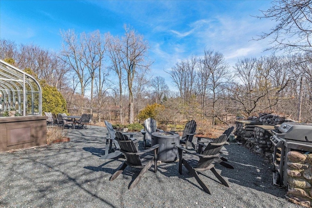 view of yard with a patio and an outdoor fire pit