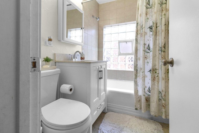 full bath with vanity, shower / bath combo with shower curtain, and toilet