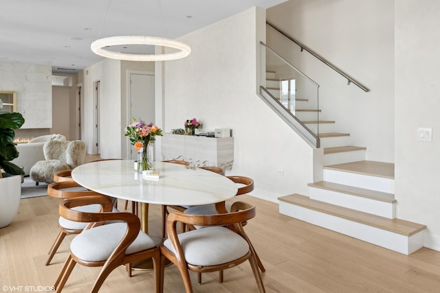 dining space featuring stairway and light wood-style flooring