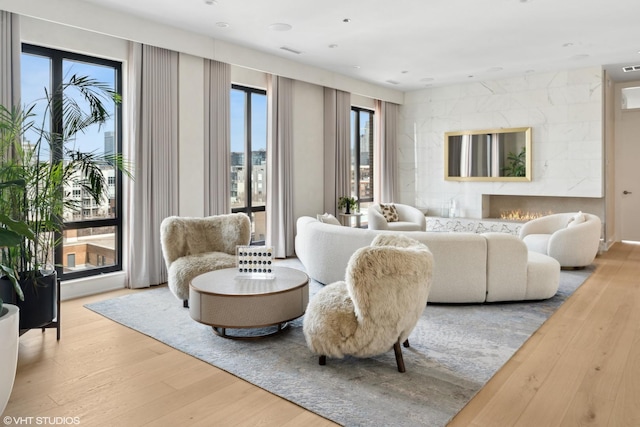 living room with visible vents, wood finished floors, and a fireplace