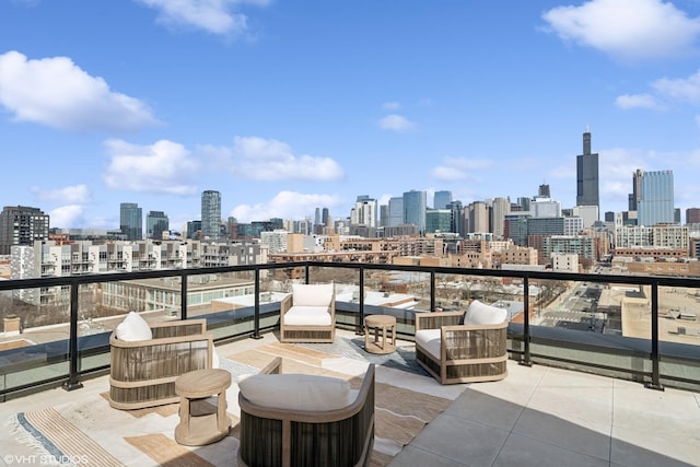 view of patio / terrace featuring a balcony, a view of city, and an outdoor hangout area