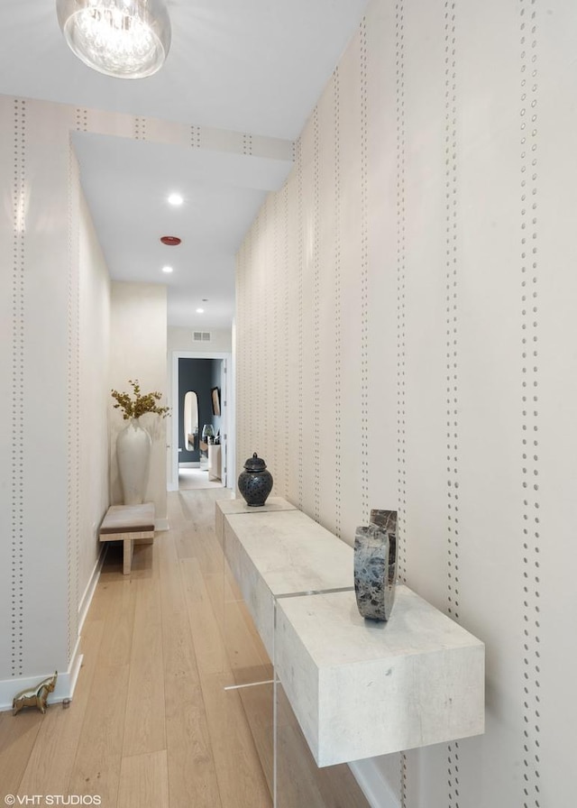 corridor featuring recessed lighting, visible vents, baseboards, and hardwood / wood-style flooring