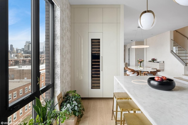 interior space with light wood finished floors, a view of city, and stairs