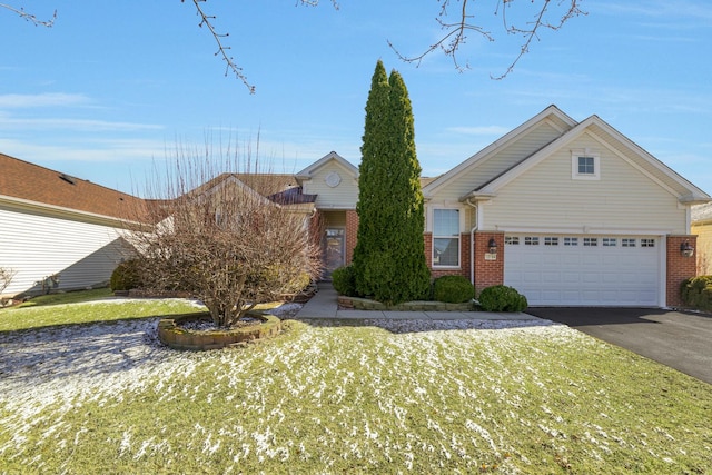 view of front of home with brick siding, an attached garage, and aphalt driveway