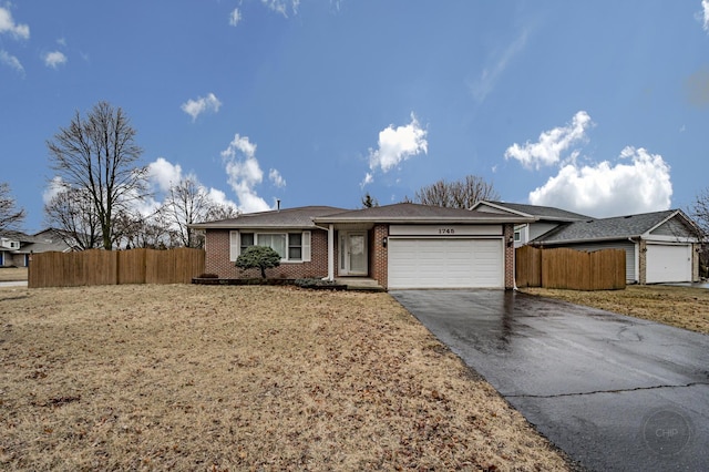 ranch-style home featuring driveway, brick siding, an attached garage, and fence