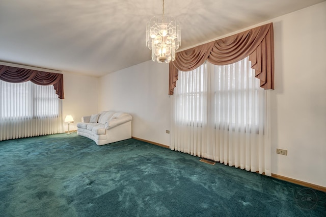 unfurnished room featuring baseboards, visible vents, a chandelier, and carpet flooring