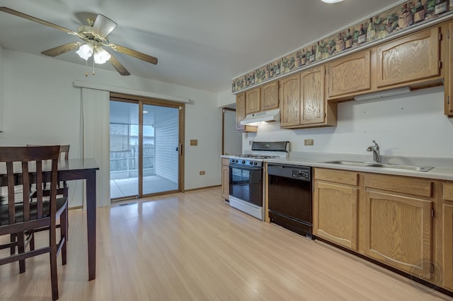 kitchen with light wood-style flooring, under cabinet range hood, a sink, dishwasher, and gas range