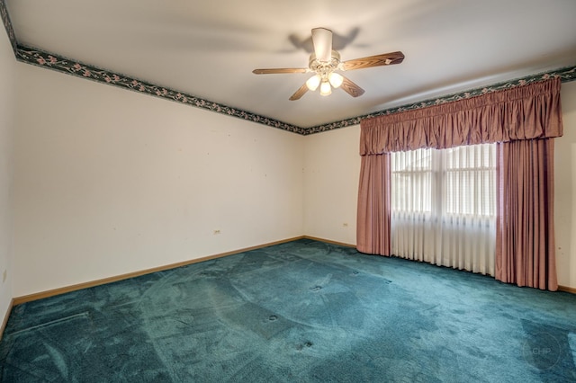 spare room featuring ceiling fan, carpet floors, and baseboards