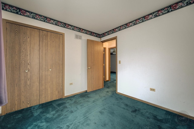 unfurnished bedroom with a closet, carpet flooring, visible vents, and baseboards