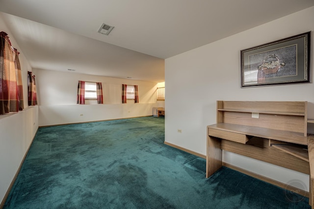 carpeted spare room featuring visible vents and baseboards