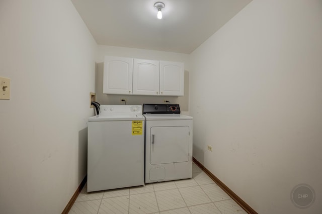 washroom with washer and dryer, cabinet space, and baseboards