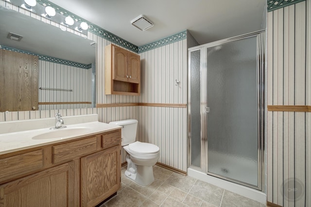 full bathroom featuring toilet, visible vents, vanity, a shower stall, and tile patterned floors