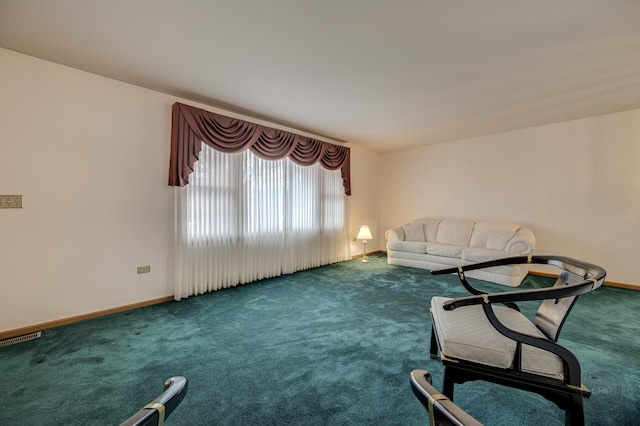 unfurnished living room with carpet, visible vents, and baseboards