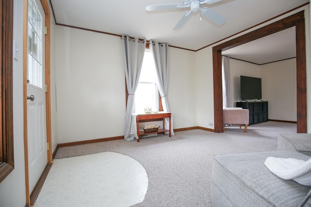 interior space with ornamental molding, ceiling fan, and baseboards