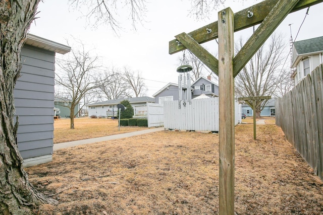 view of yard featuring a residential view and fence