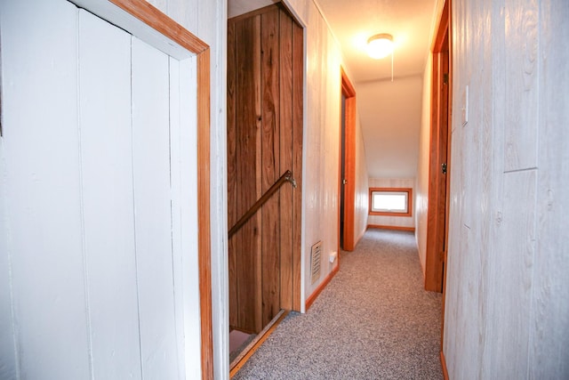 hallway featuring light carpet and visible vents