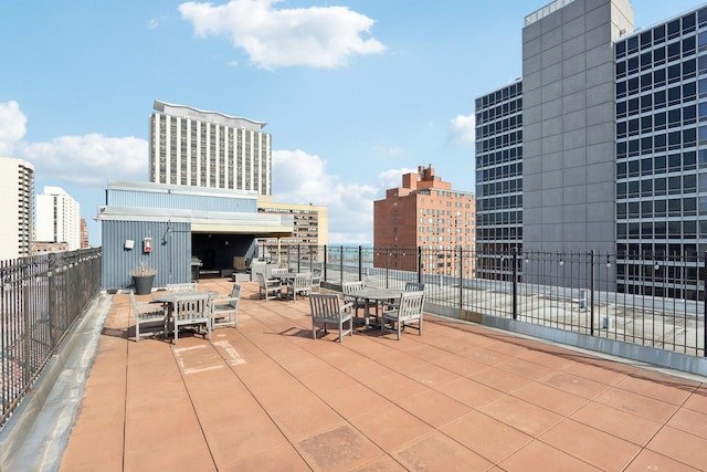 view of patio featuring a view of city and outdoor dining space