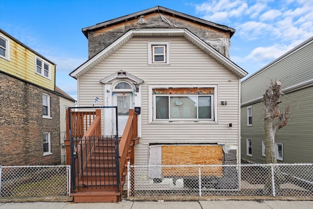 view of front of house featuring a fenced front yard and a gate