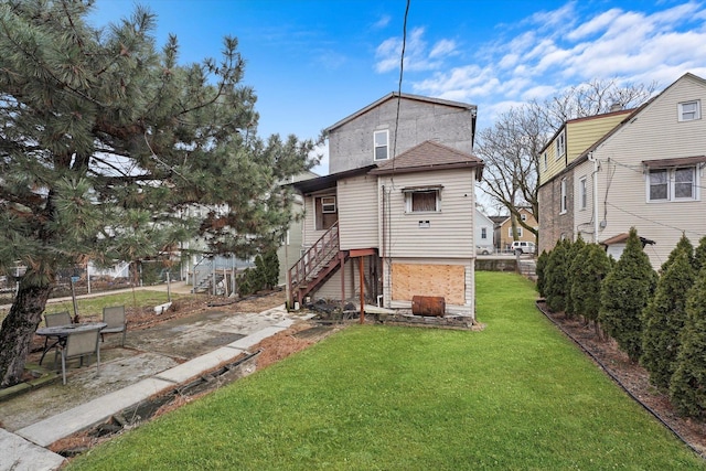 back of property featuring fence and a yard