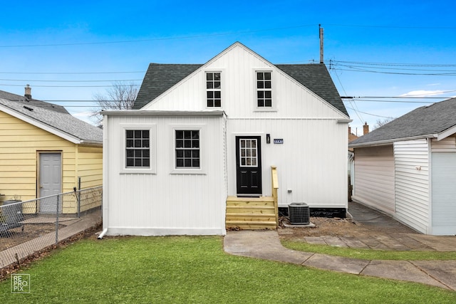 view of front of house with entry steps, a shingled roof, fence, and central AC unit