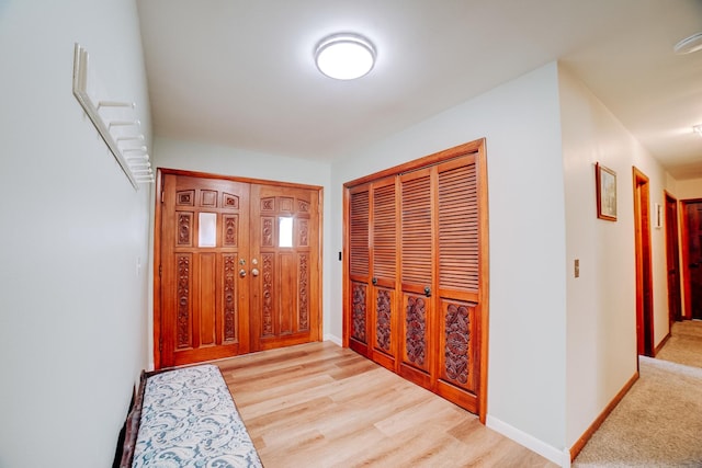 hall with wood finished floors and baseboards