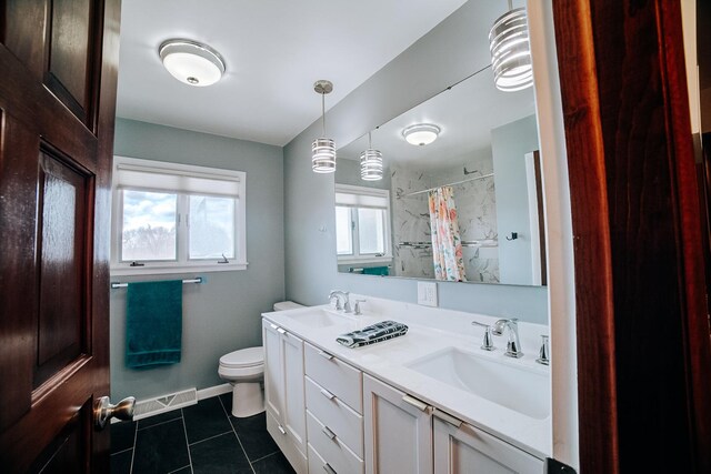 full bathroom featuring a shower with shower curtain, tile patterned floors, visible vents, and a sink